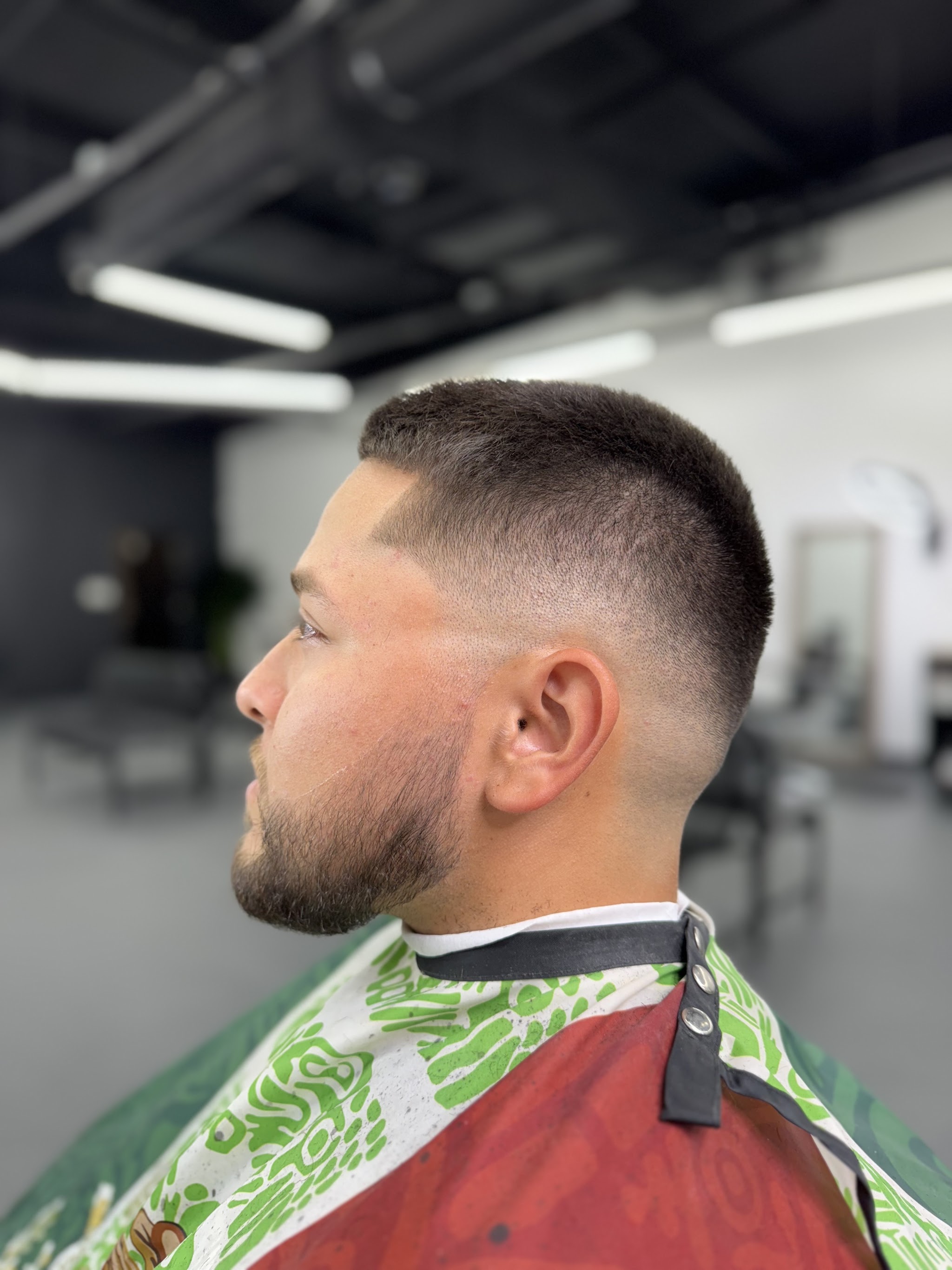 Skin fade with a shaped beard, side profile