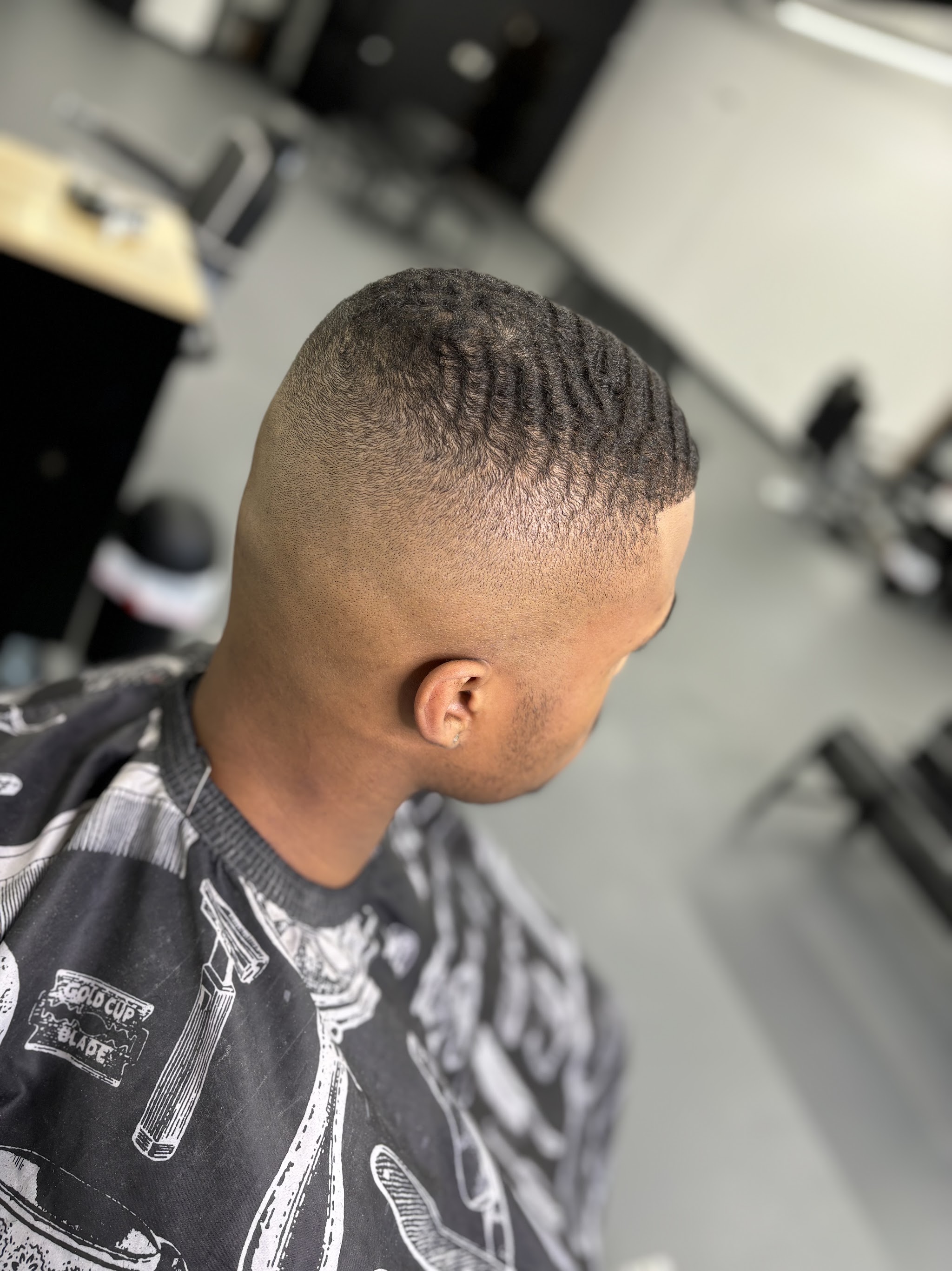 Skin fade with defined waves on top