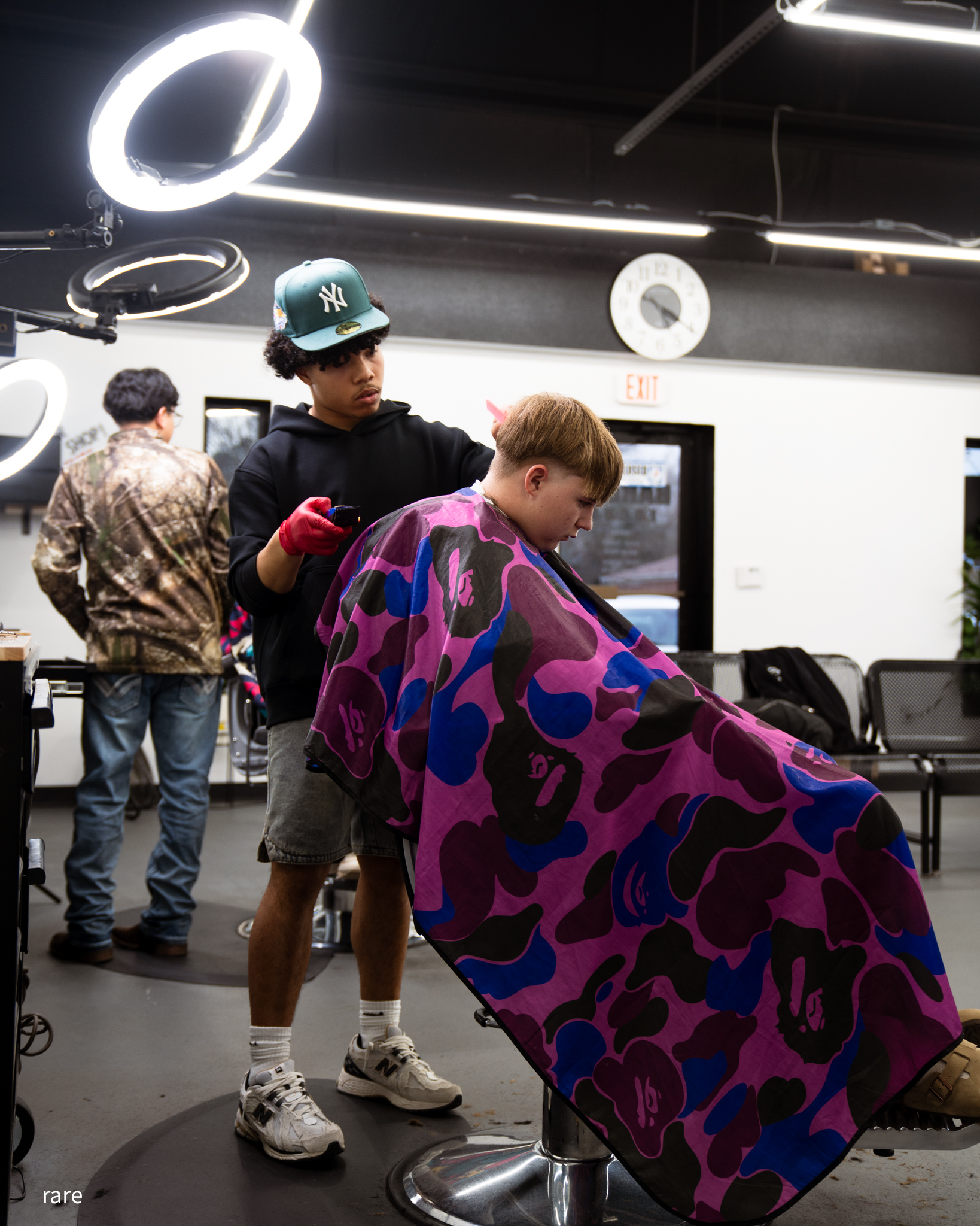 A barber at work under the ring lights