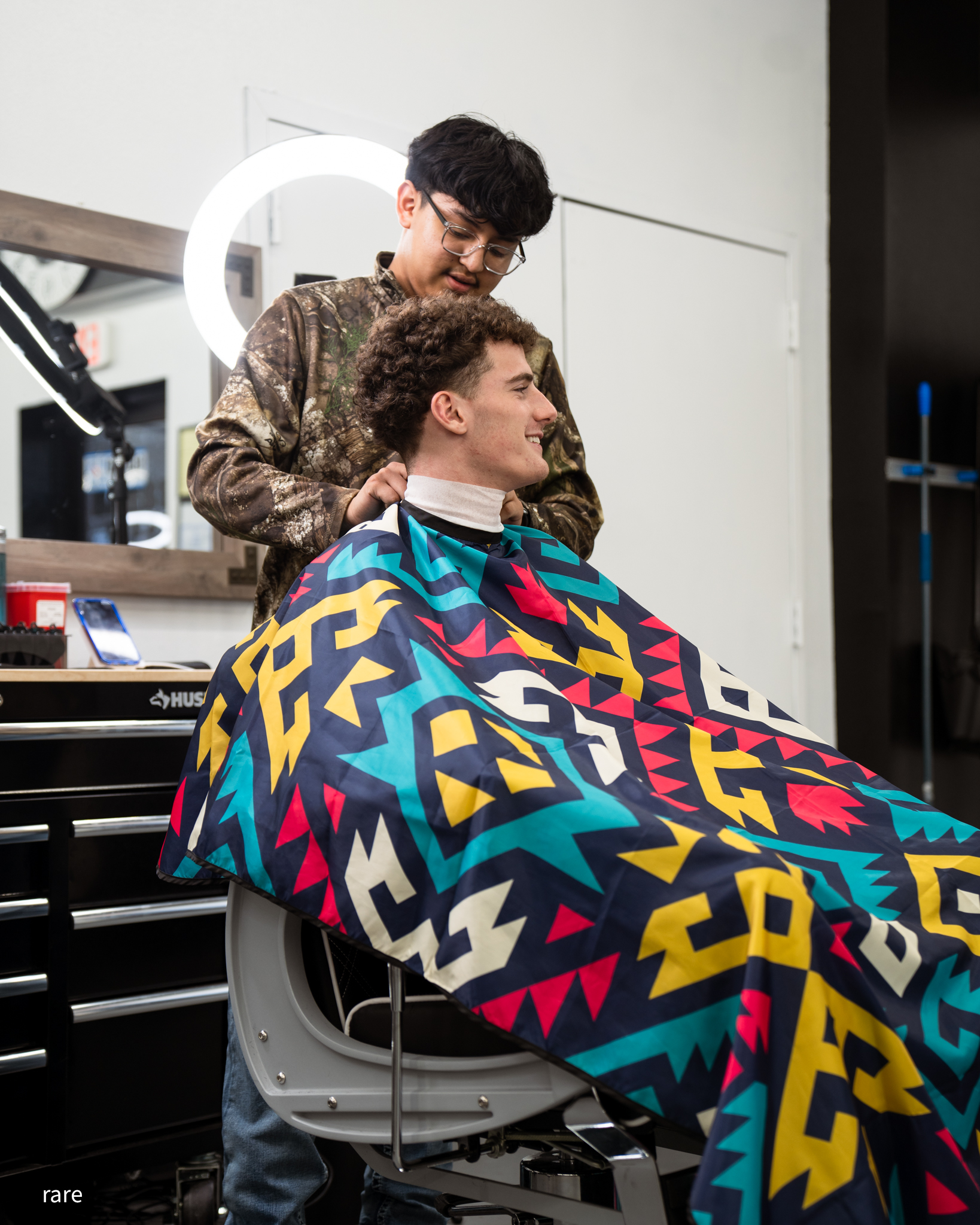 Barber and client mid-cut