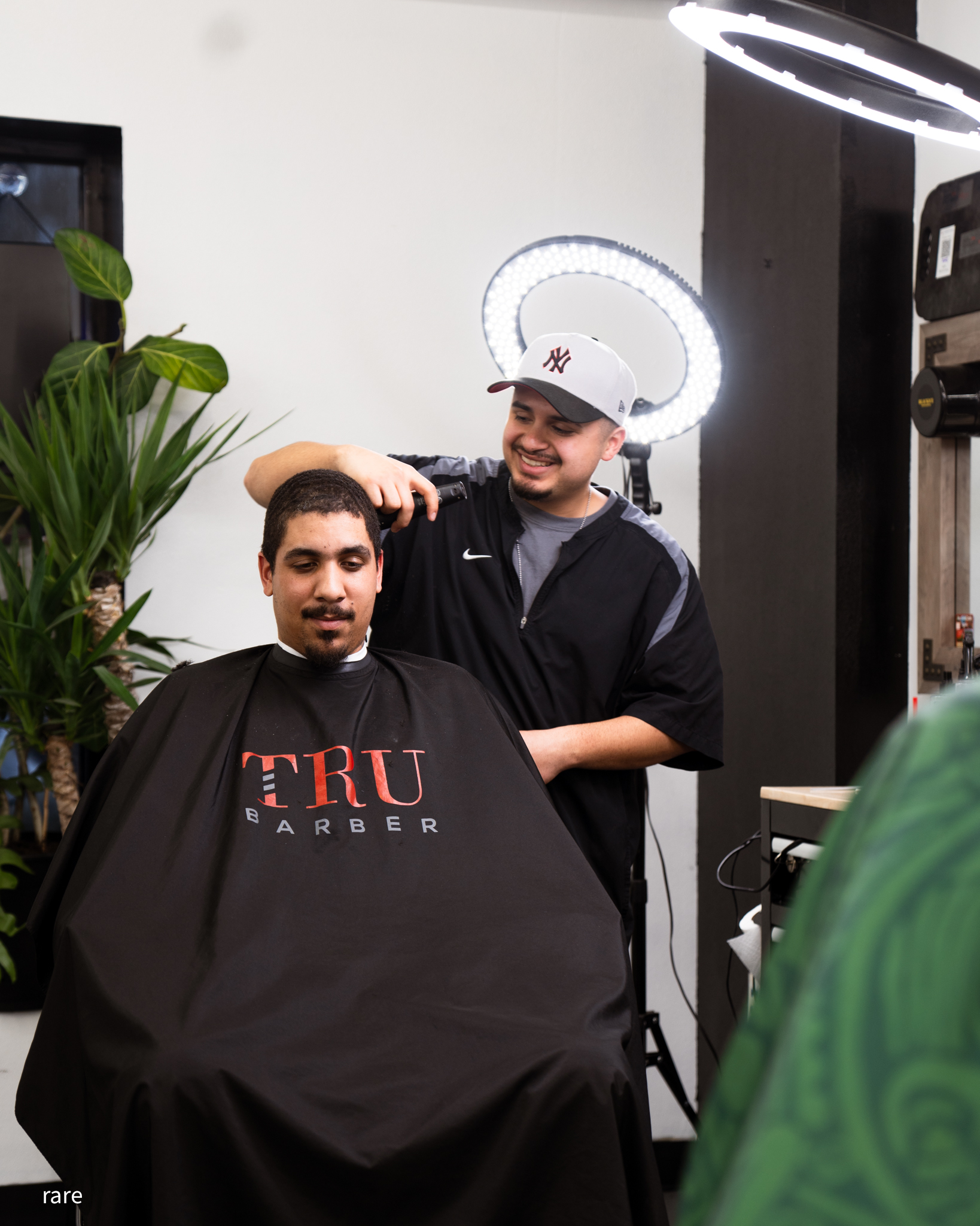 Barber finishing a cut